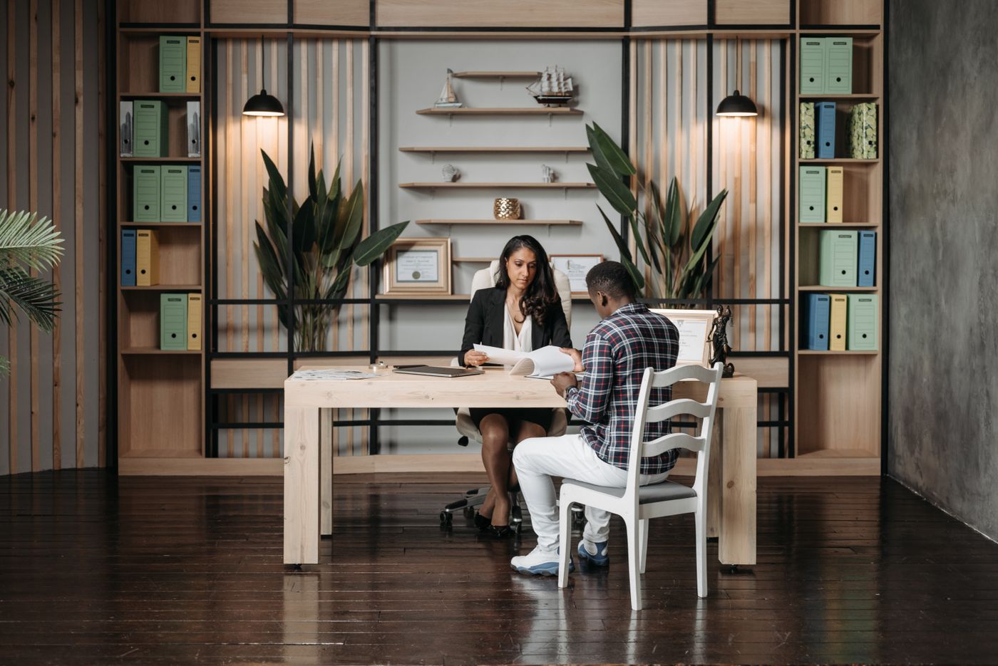 A lawyer going through documents with a client across a desk.