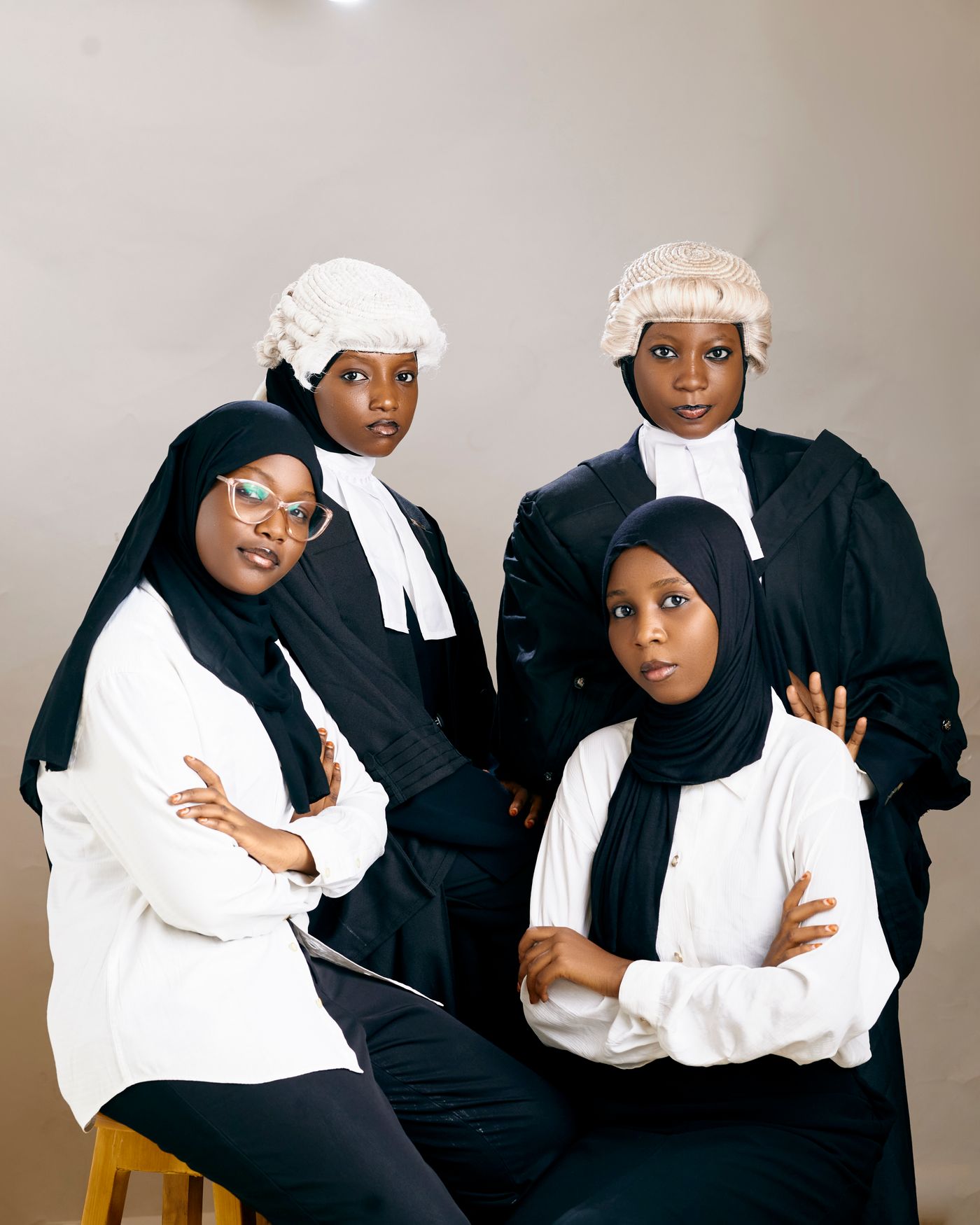 Four advocates in wig and gown, standing together.